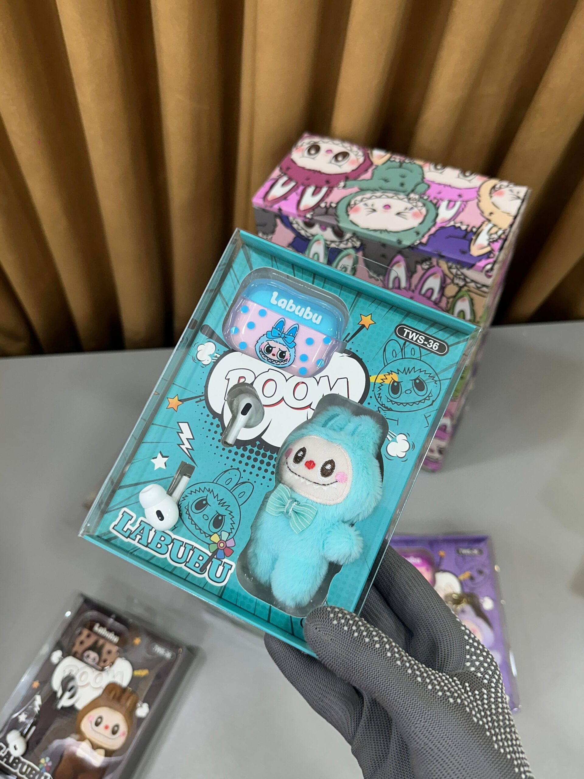 AirPods Pro 2 with Labubu cover and Labubu doll keychain